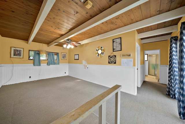 carpeted spare room with beamed ceiling and wooden ceiling