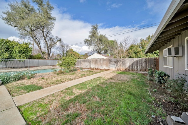 view of yard with a fenced in pool and cooling unit