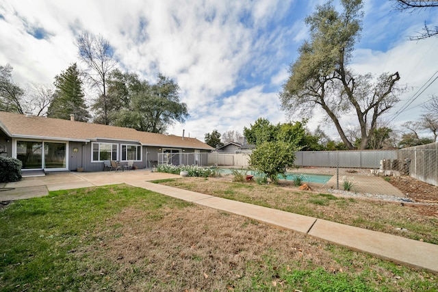 view of yard with a fenced in pool and a patio