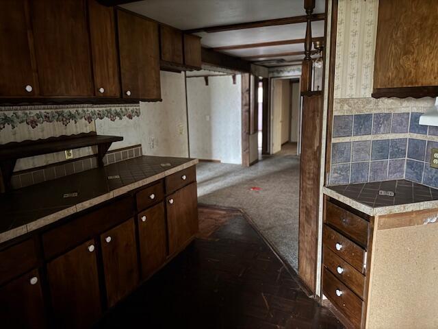 kitchen featuring dark brown cabinetry