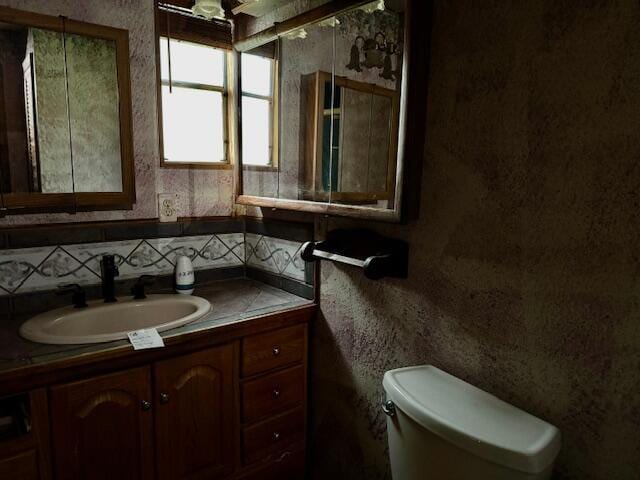 bathroom featuring vanity and toilet