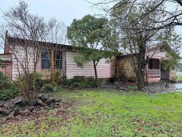 view of side of home featuring a yard