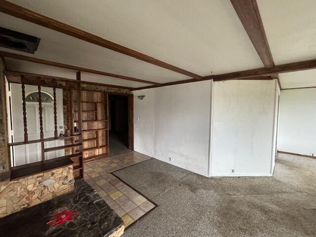 unfurnished living room featuring crown molding, beam ceiling, and dark colored carpet