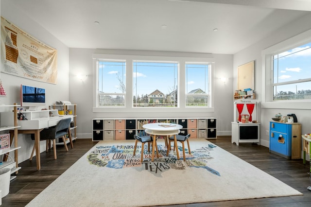 recreation room featuring a wealth of natural light and dark wood-type flooring