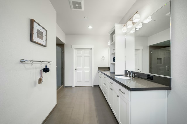 bathroom featuring vanity and an enclosed shower