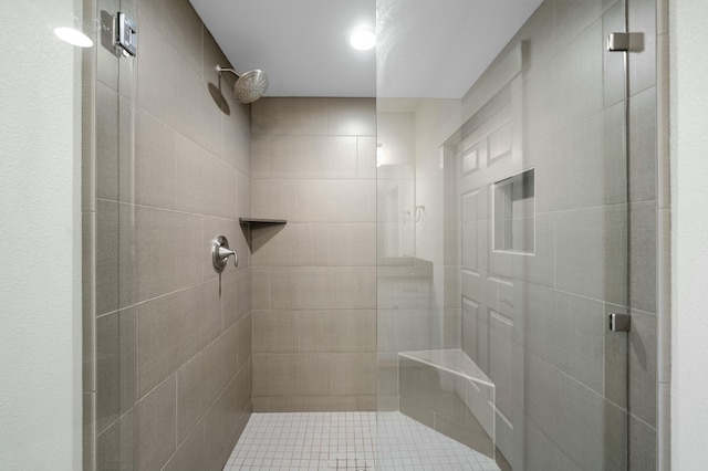 bathroom with a shower with door