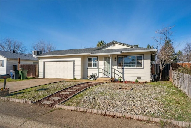 ranch-style home featuring cooling unit, a garage, and a front yard