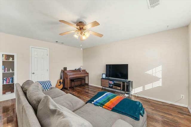 living room with dark wood-type flooring and ceiling fan