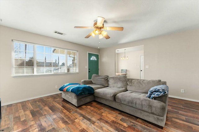 living room with dark wood-type flooring and ceiling fan