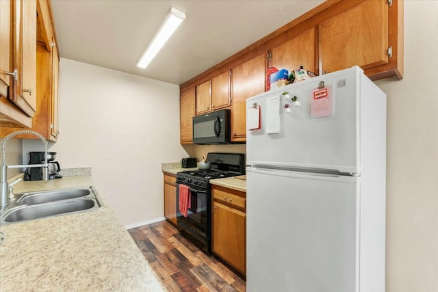 kitchen featuring dark hardwood / wood-style flooring, sink, and black appliances