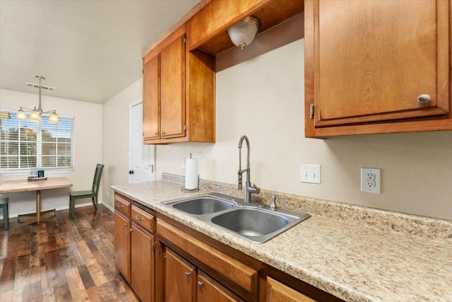 kitchen with pendant lighting, sink, and dark hardwood / wood-style flooring