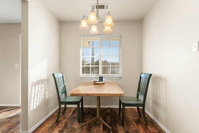 dining area with an inviting chandelier and dark hardwood / wood-style flooring