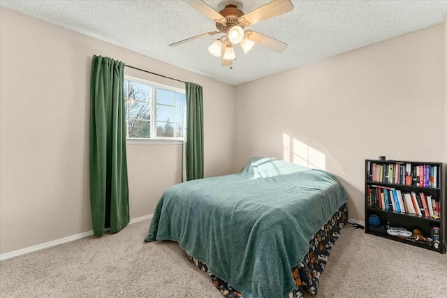 bedroom featuring light carpet, ceiling fan, and a textured ceiling