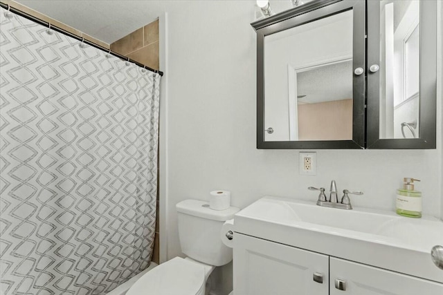 bathroom featuring vanity, toilet, and a shower with shower curtain