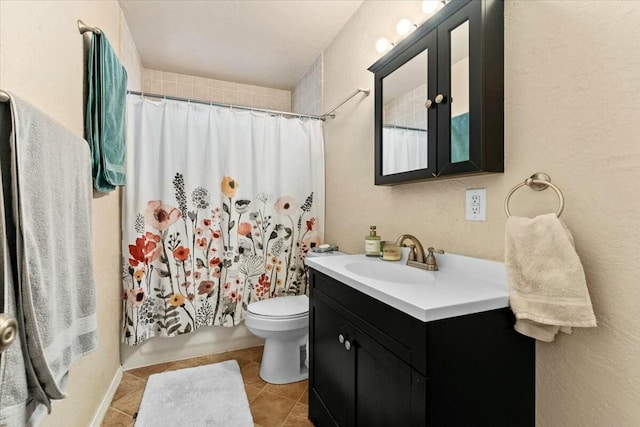 bathroom featuring vanity, tile patterned floors, and toilet