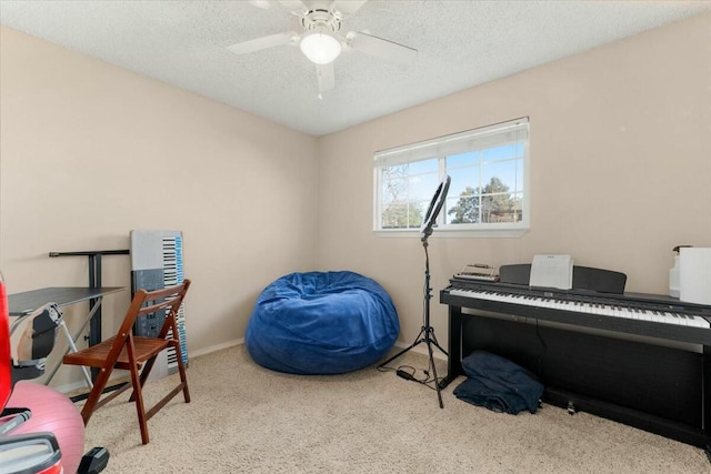 office featuring ceiling fan, light carpet, and a textured ceiling