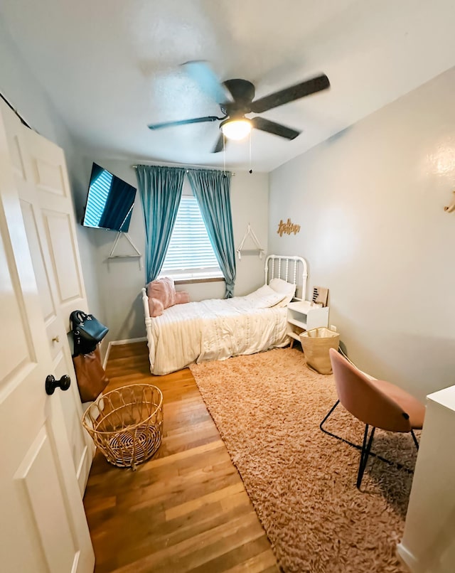 bedroom featuring hardwood / wood-style flooring and ceiling fan