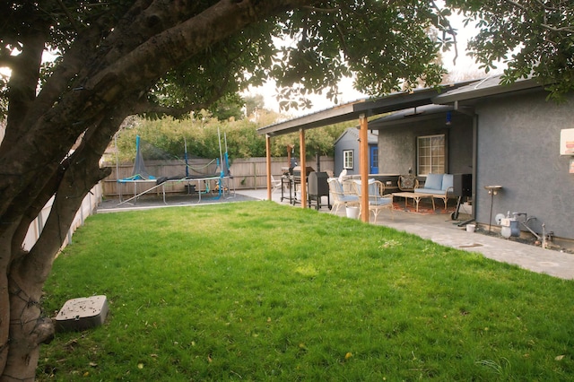 view of yard with a patio area and a trampoline