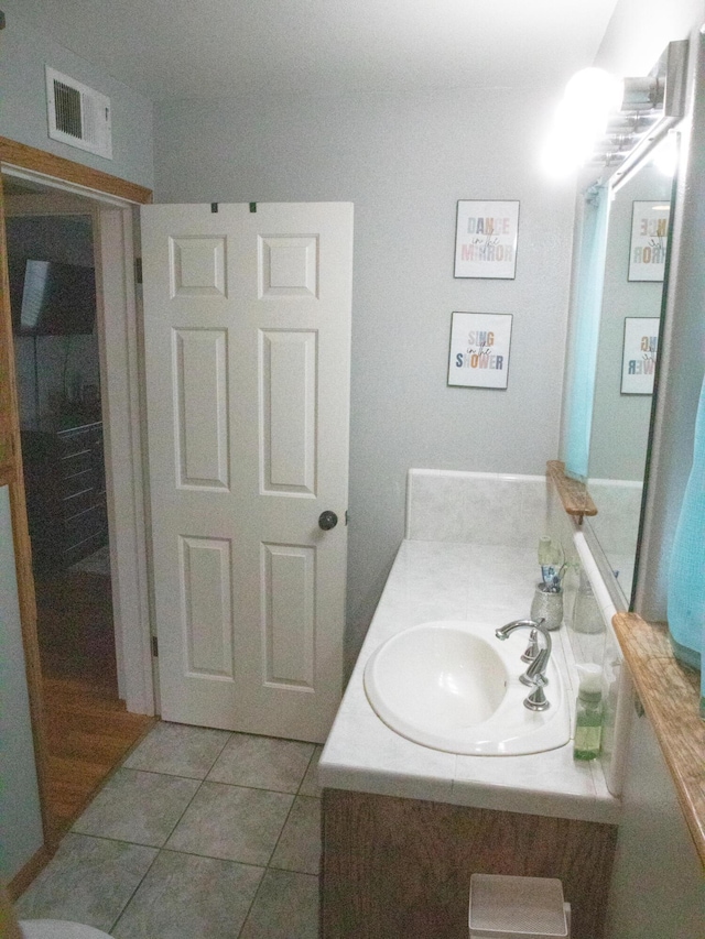 bathroom with vanity and tile patterned flooring