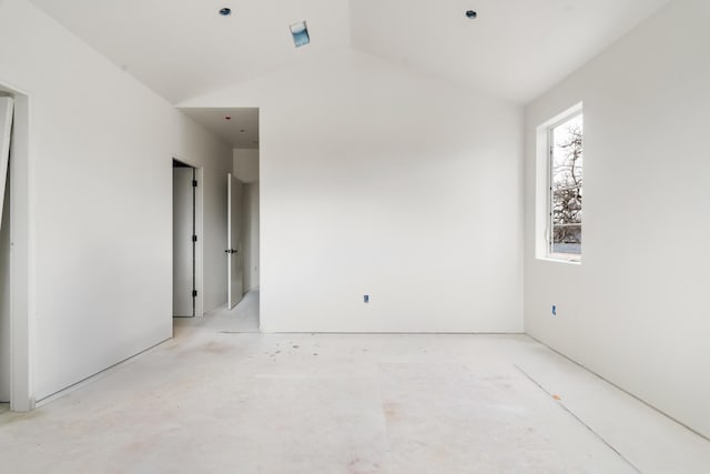 empty room featuring vaulted ceiling