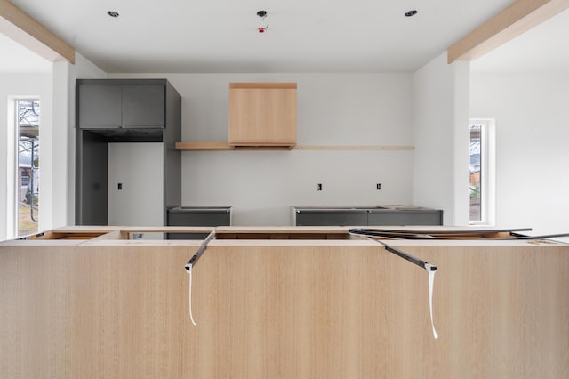 kitchen with light brown cabinets and a wealth of natural light