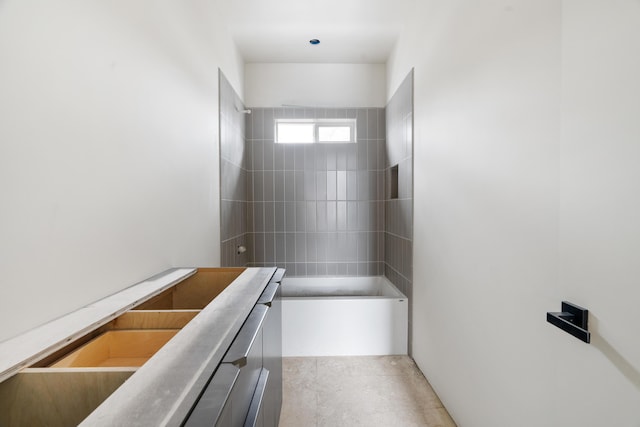 bathroom with tiled shower / bath combo and concrete floors