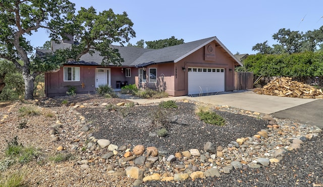 single story home with an attached garage, driveway, and stucco siding