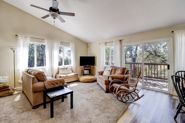 living room with lofted ceiling, ceiling fan, and wood finished floors