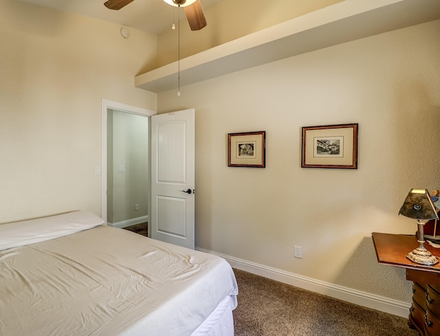 bedroom with ceiling fan, dark colored carpet, and baseboards