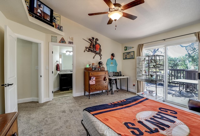 bedroom featuring ceiling fan, carpet floors, baseboards, access to exterior, and ensuite bath