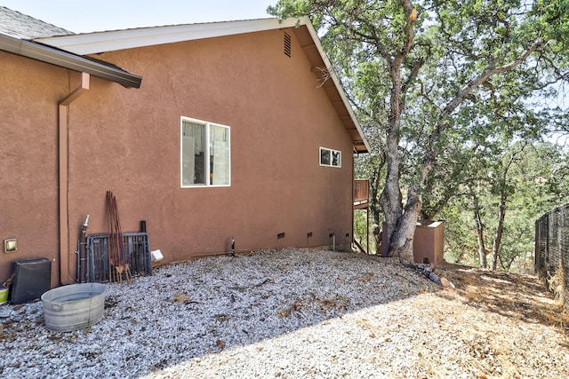 view of side of home with stucco siding