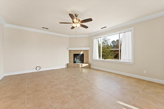 unfurnished living room with ornamental molding, a tile fireplace, and light tile patterned floors