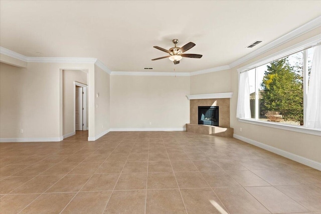 unfurnished living room with crown molding, a premium fireplace, ceiling fan, and light tile patterned flooring