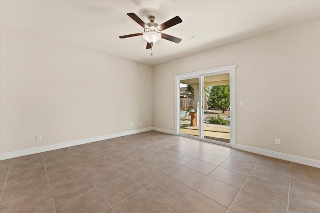 tiled spare room featuring ceiling fan