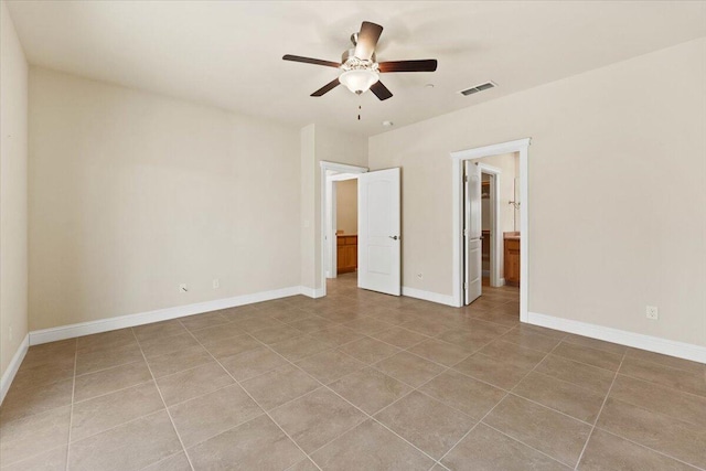 unfurnished bedroom with ceiling fan, ensuite bath, and light tile patterned floors