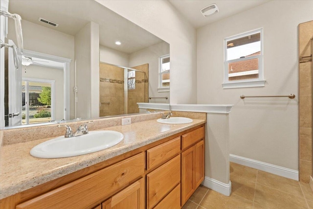 bathroom featuring walk in shower, vanity, and tile patterned flooring