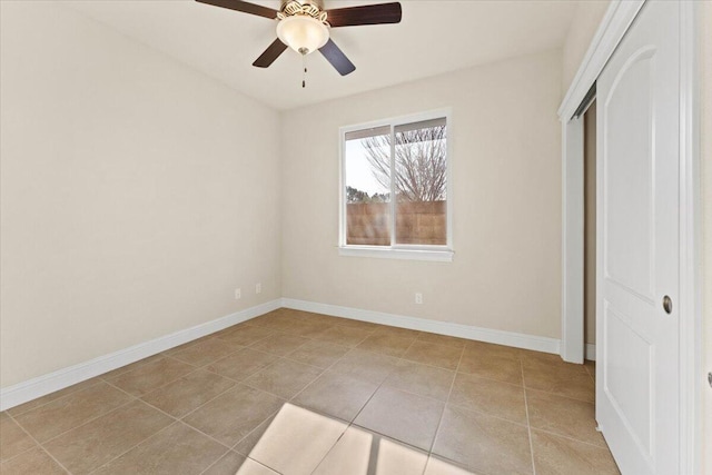 unfurnished bedroom with light tile patterned floors, a closet, and ceiling fan