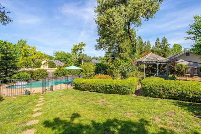 view of yard featuring a fenced in pool and a gazebo