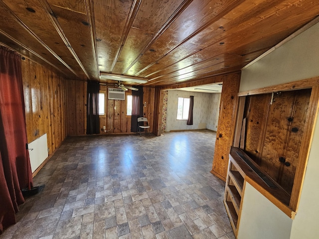 unfurnished room with a wall mounted air conditioner, wood ceiling, and wood walls