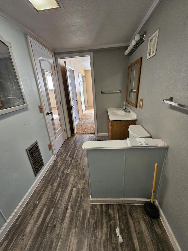 bathroom with vanity, wood-type flooring, and a textured ceiling