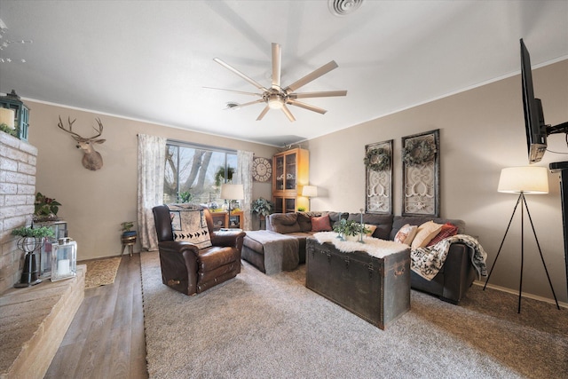 living room with ceiling fan and ornamental molding