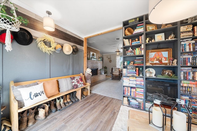 interior space featuring wood-type flooring and a brick fireplace