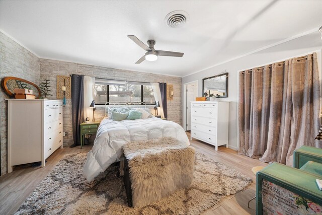 bedroom featuring crown molding, ceiling fan, and light wood-type flooring