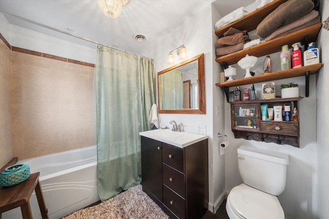 full bathroom with vanity, shower / tub combo, and toilet