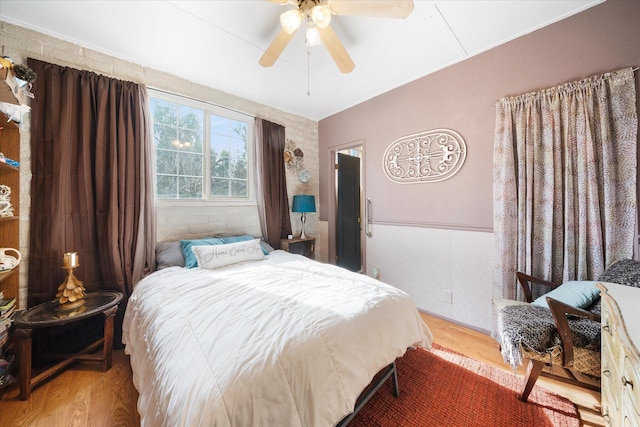 bedroom with wood-type flooring and ceiling fan