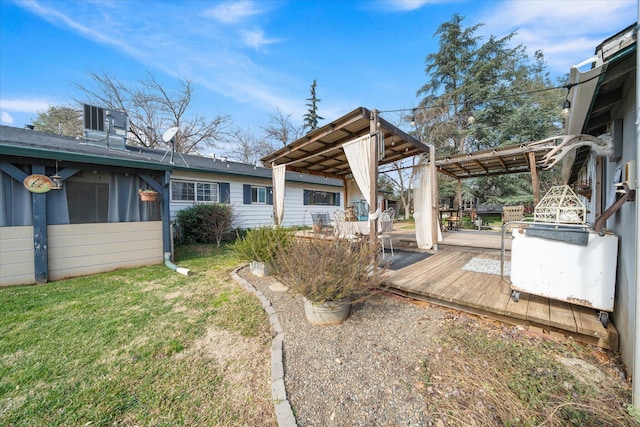 view of yard with a wooden deck and central AC