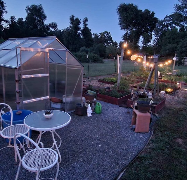 yard at dusk featuring an outbuilding