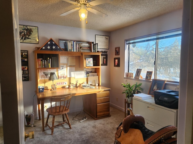 office space featuring ceiling fan, light colored carpet, and a textured ceiling