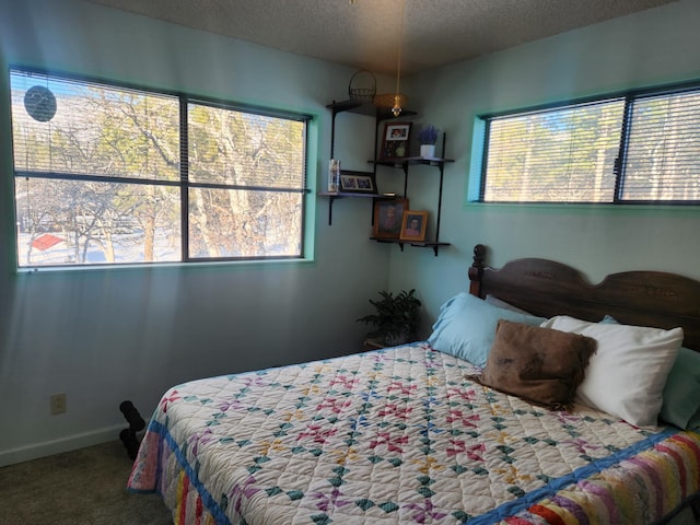 bedroom featuring carpet floors and a textured ceiling