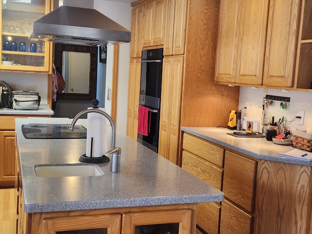 kitchen with black double oven, island exhaust hood, and sink